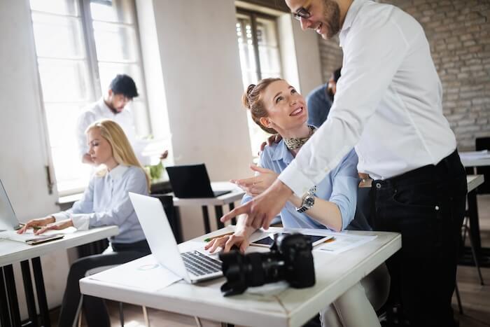 two marketing team members in the office discussing the right content for manufacturers