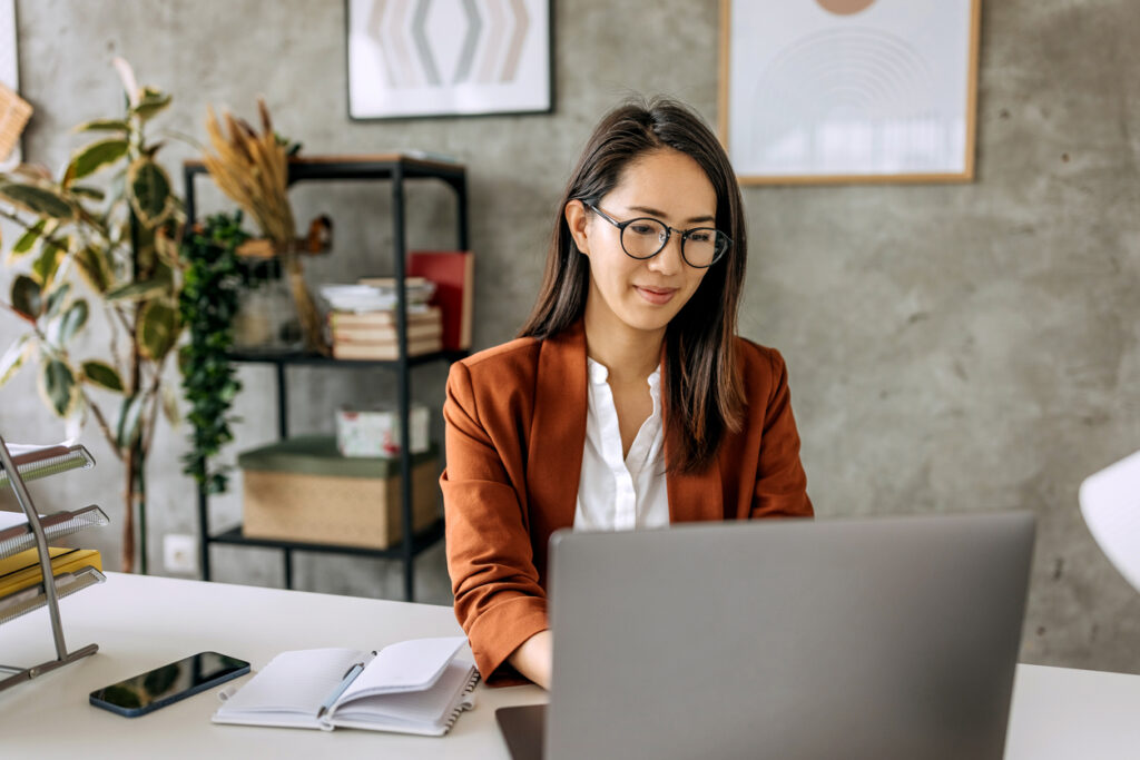 Young professional woman working on her laptop in an office